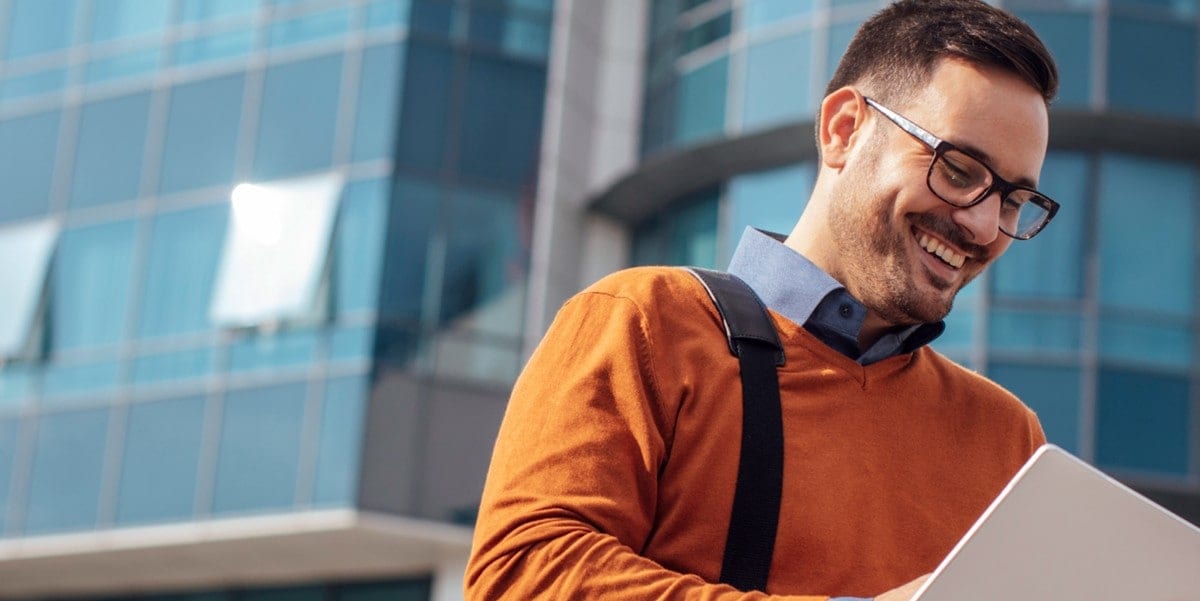 professional man outside, looking at tablet