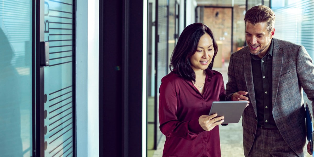 two professionals in office reviewing document