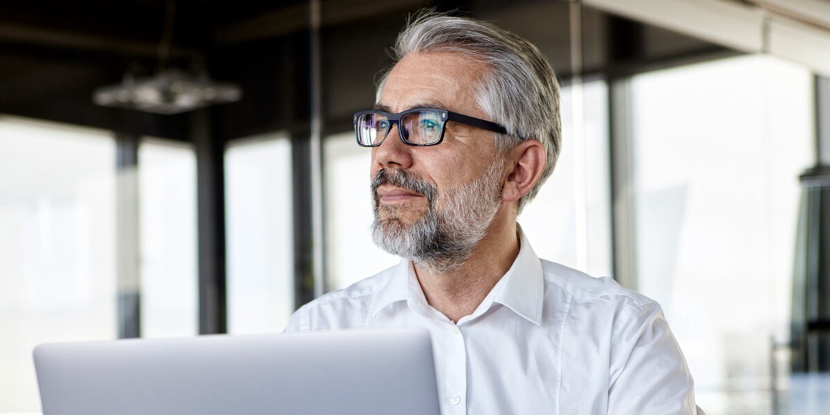 man in the office, laptop in front of him
