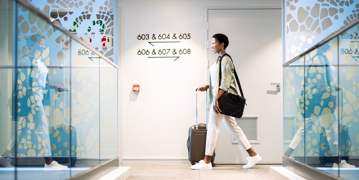 traveler walking through airport with luggage
