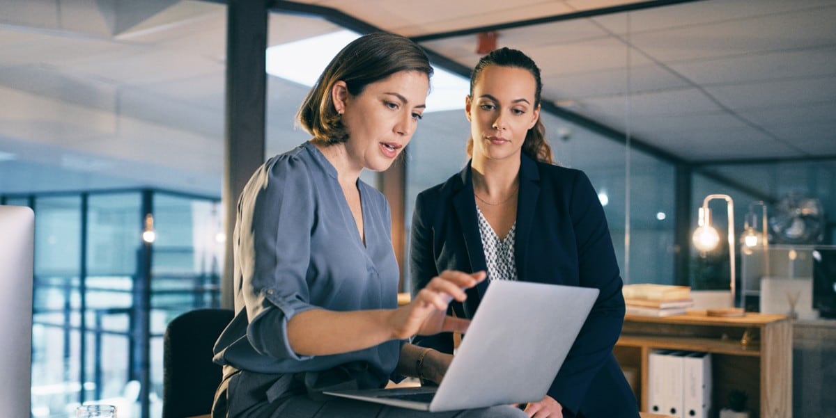 two professionals in the office looking at computer