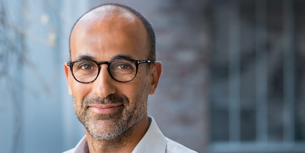 professional man with glasses smiling