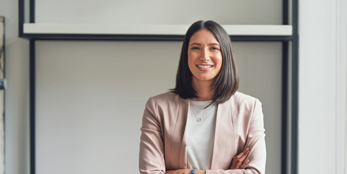 professional woman smiling with arms crossed