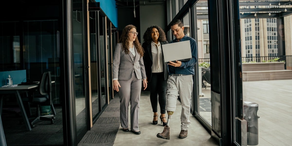 group of prodessionals in the office, walking through hallway