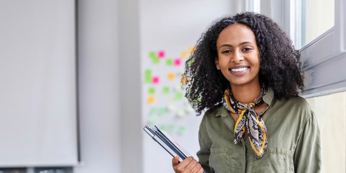 professional woman in office holding tablet
