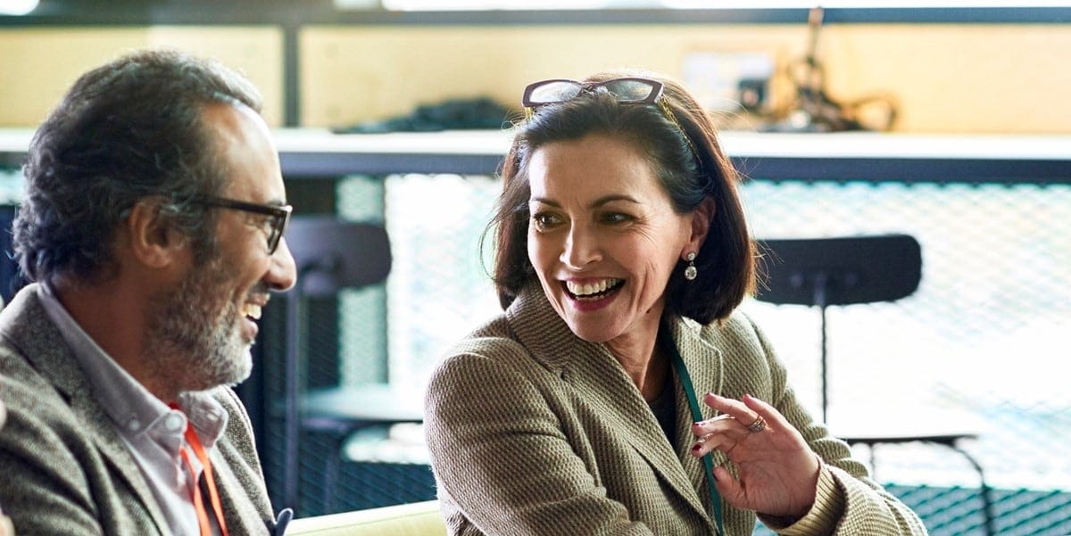 two professionals in office in discussion